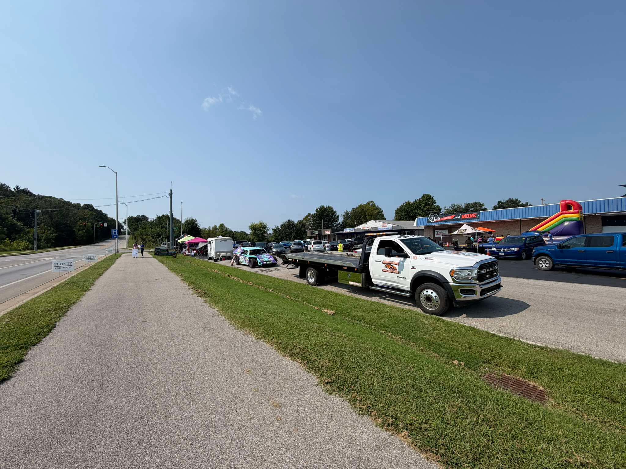 Community organizations, service vehicles, and families gathered along Clay Drive for the event